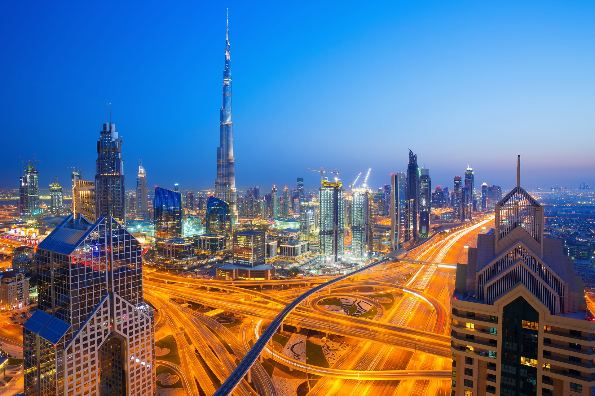 Modern skyscrapers, busy evening highways in luxury Dubai city,UAE