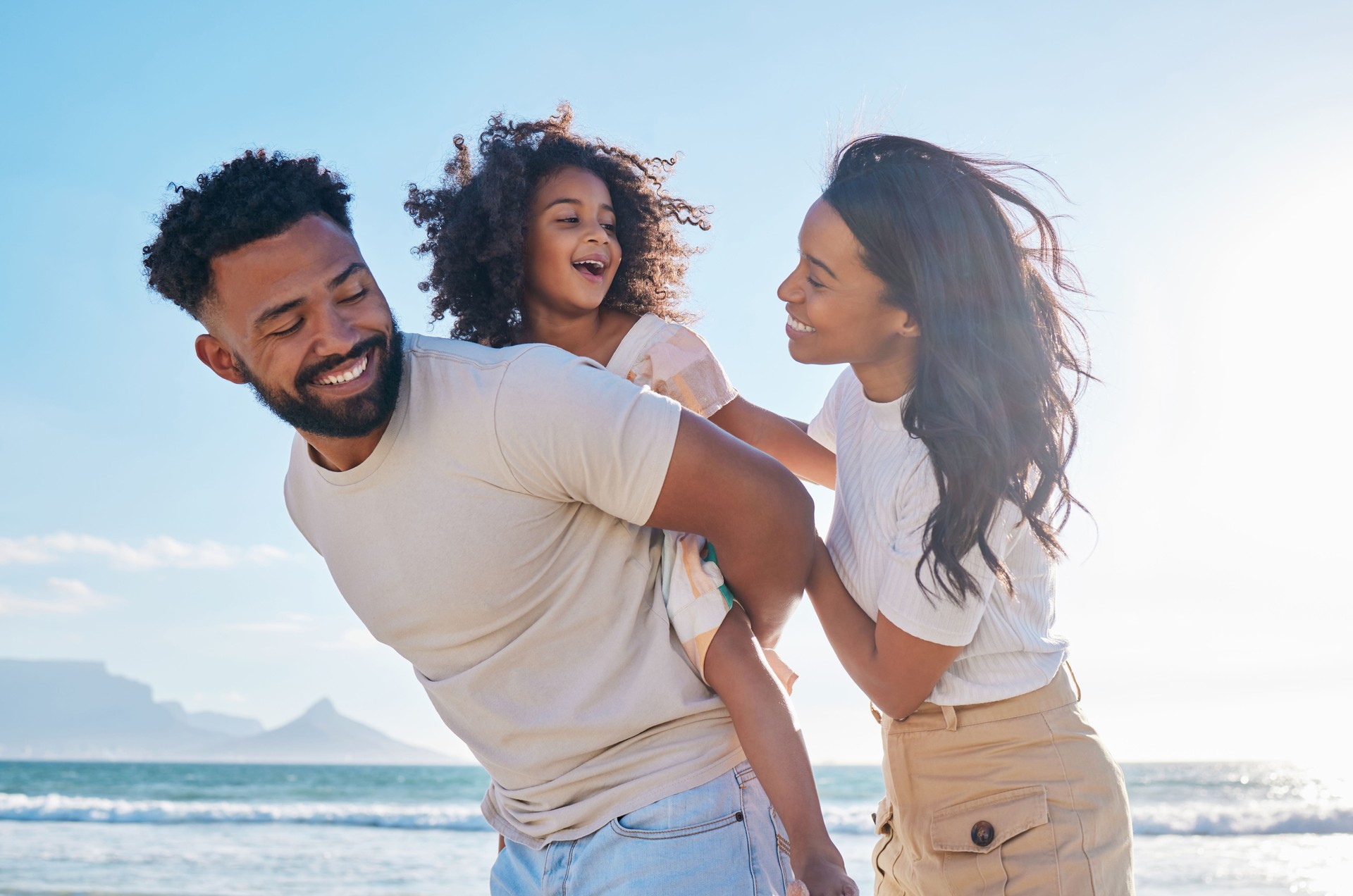 Cropped shot of an affectionate young family of three taking a walk on the beach